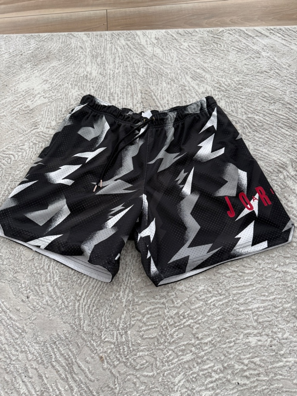 Jordan Men's Black Athletic Shorts with Gray Lightning Print & Red Logo